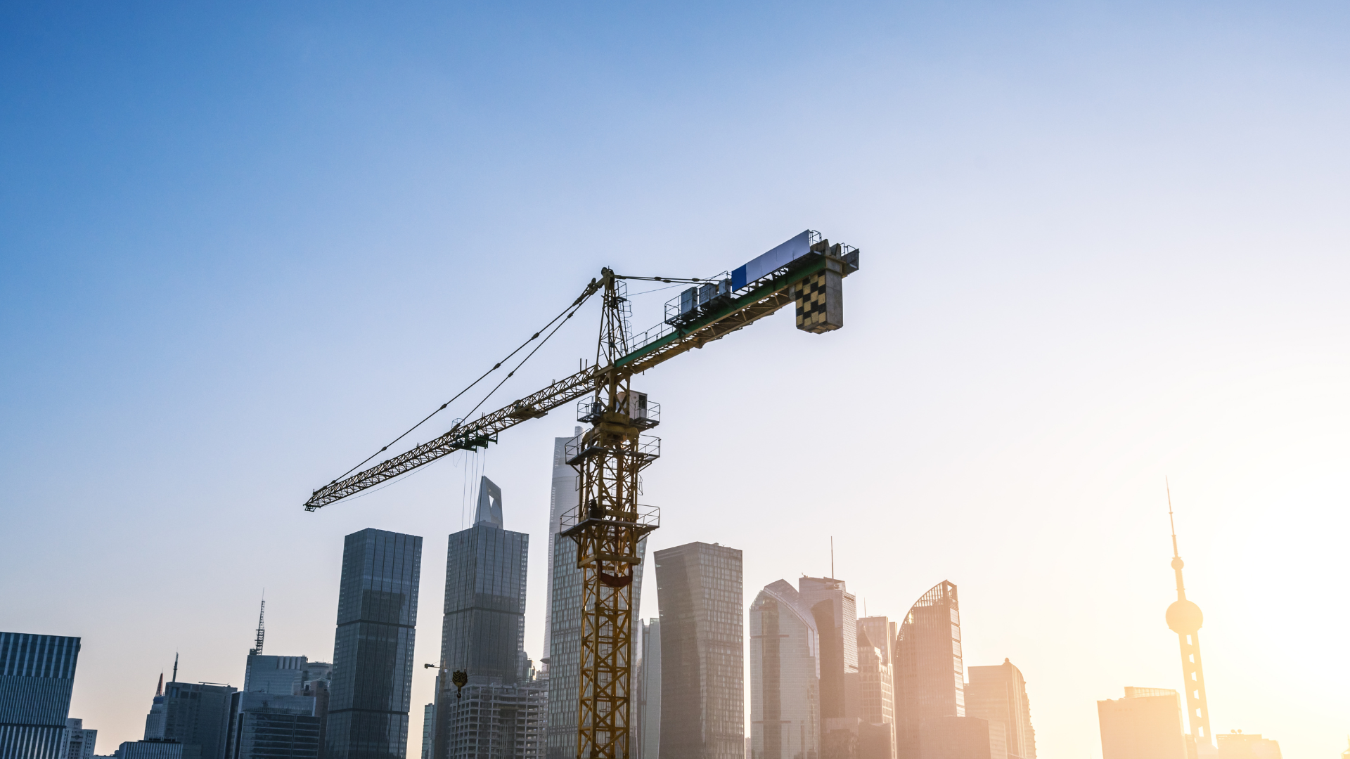 Construction crane above a city skyline